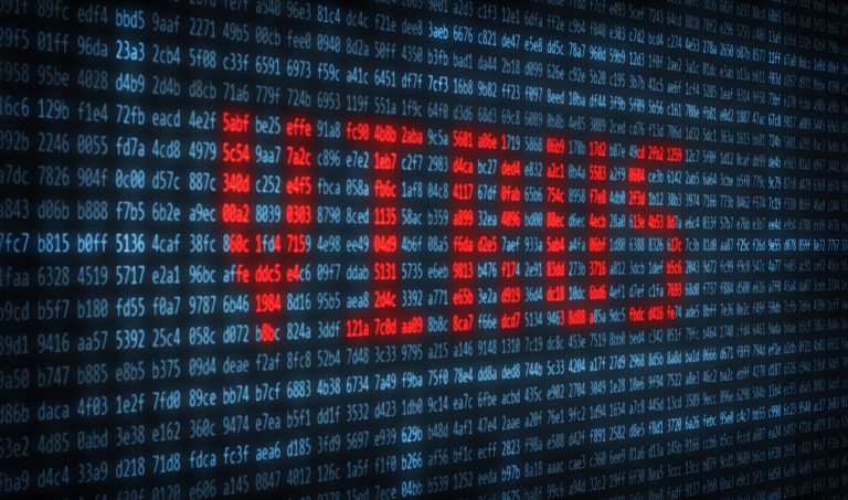 Close-up of a computer screen displaying a red virus alert within lines of code. Halang virus.