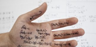 Tukar Gambar Kepada Text Hand covered in math formulas and equations.