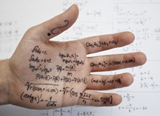 Tukar Gambar Kepada Text Hand covered in math formulas and equations.