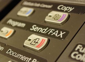 Hantar Faks Percuma Dari Komputer ke Sekolah Close-up of a multifunction printer's control panel, showing buttons for copy, send/fax, and program functions.