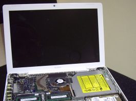 Disassembled MacBook laptop, showing internal components including RAM and hard drive. Ideal for teachers needing a reliable device.