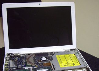 Panduan Membeli Laptop untuk Cikgu Disassembled MacBook laptop, showing internal components including RAM and hard drive. Ideal for teachers needing a reliable device.