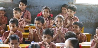 Dana Transformasi Kelas Biasa ke Kelas Frog Happy schoolchildren in a classroom, clapping enthusiastically.