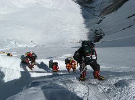 Mount Everest climbers ascending, using ropes. A challenging Everest climb.