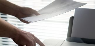 Berkongsi Printer Menggunakan Google Chrome Person printing documents using a printer. Google Chrome sharing is not depicted.