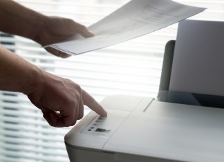 Berkongsi Printer Menggunakan Google Chrome Person printing documents using a printer. Google Chrome sharing is not depicted.