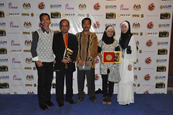 Group of award recipients posing for a photo at an awards ceremony.